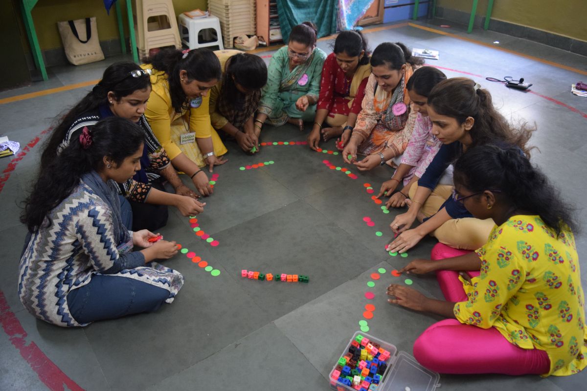 A Muktangan trainee teacher guiding young children through a play-based activity in Mumbai